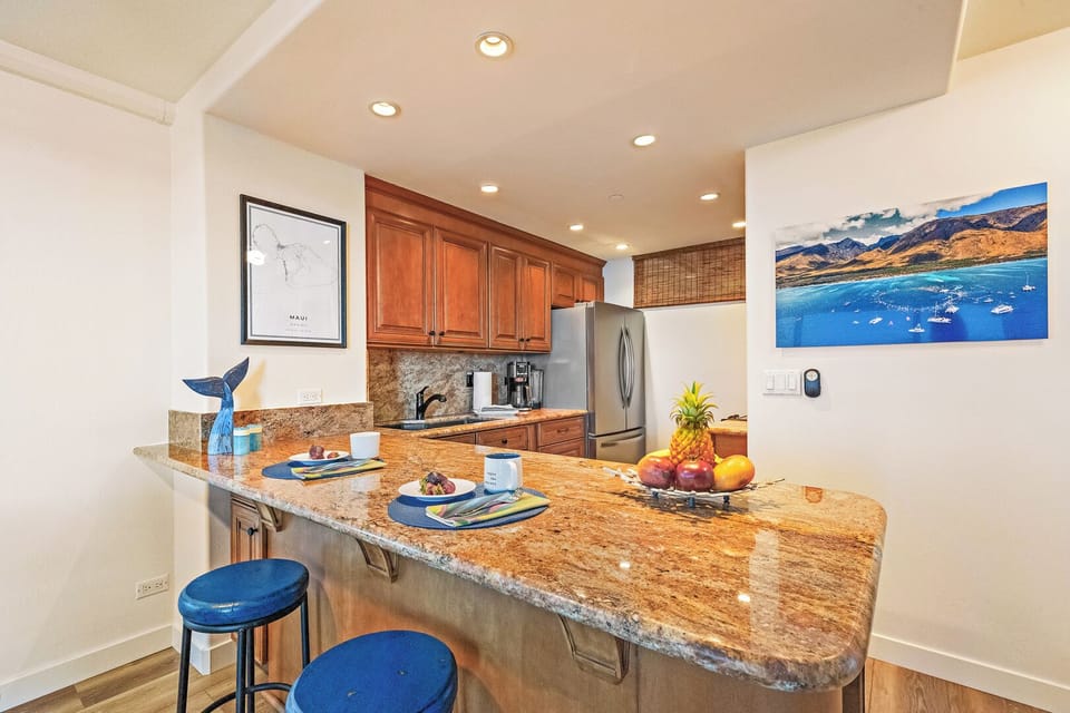 Granite-topped kitchen island at Mahana 1118 is perfect for prep or casual dining.