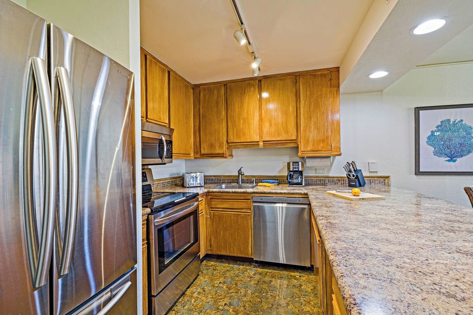 The kitchen at Kaanapali Shores 544 features modern appliances and ample space for family meals.