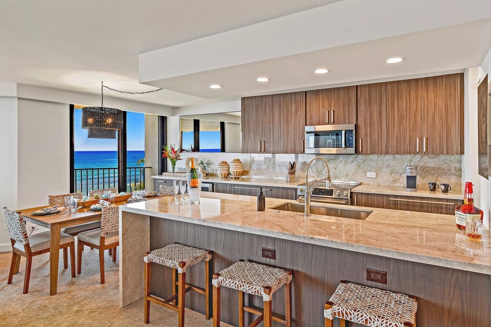 Kaanapali Shores 702's gourmet kitchen boasts ocean views and modern island vibes.