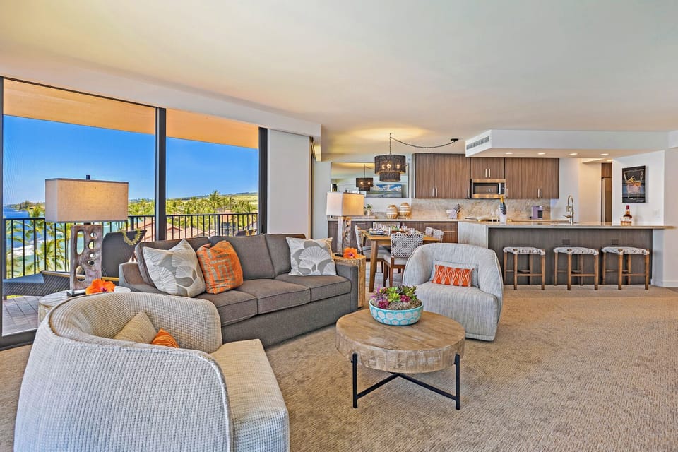 Open-concept living at Kaanapali Shores 702 with easy flow from kitchen to lanai.
