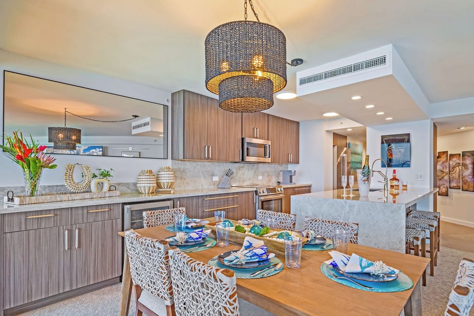 Modern dining at Kaanapali Shores 702 with a view into the kitchen, perfect for meals and conversation.