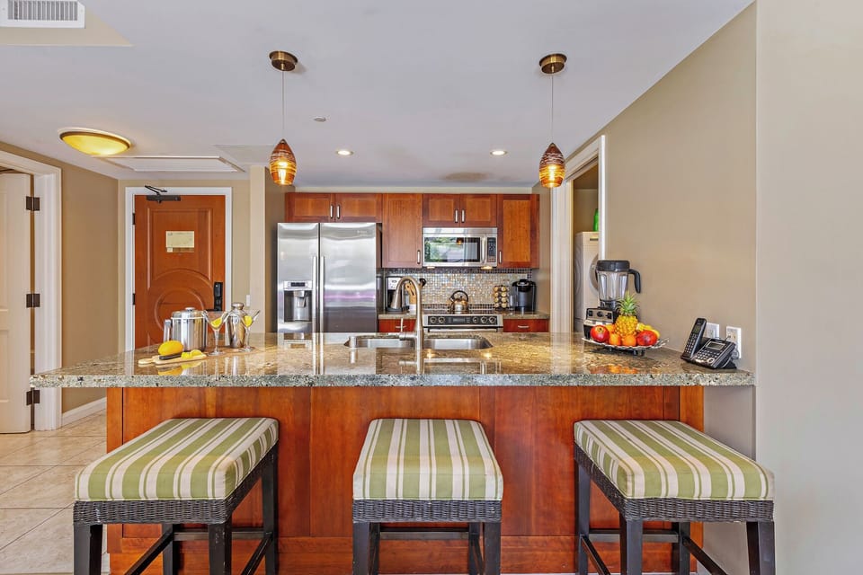 Hokulani 214 'Kamalu' features granite counters, a spacious island, and stainless Bosch appliances.