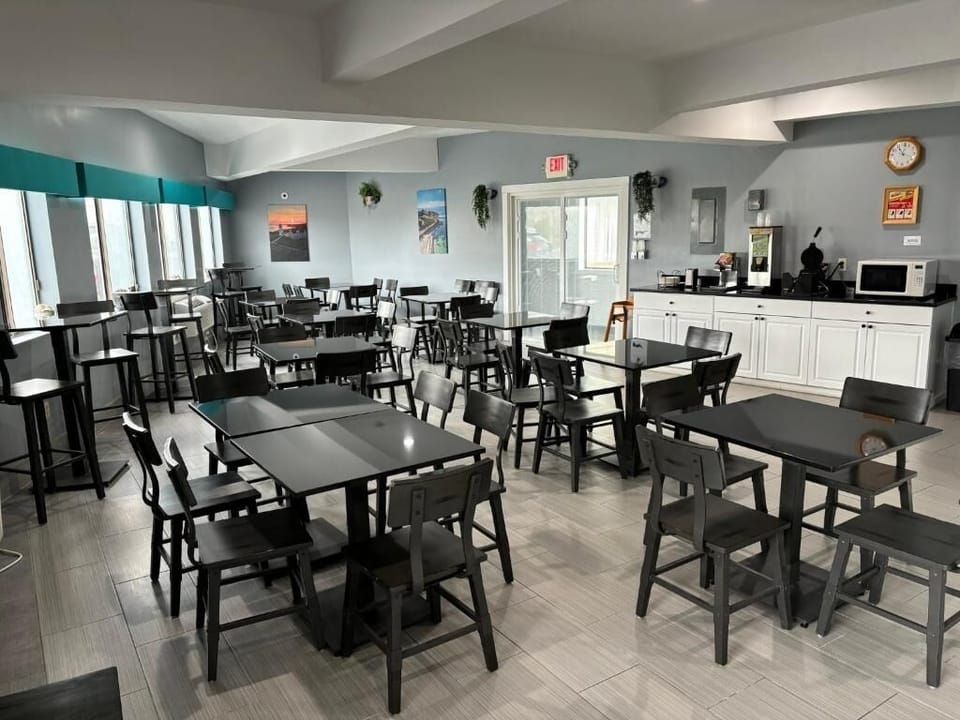 Sip coffee by the windows in a calm breakfast space.