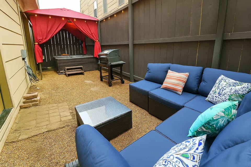 Outdoor cabana seating beside soothing jacuzzi—perfect evening chill spot.