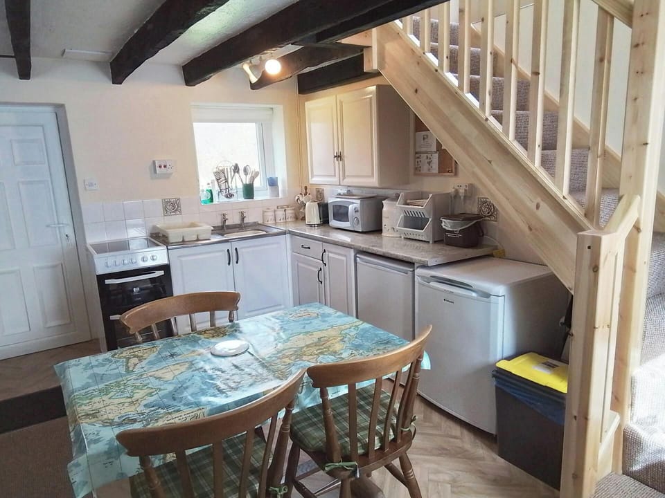Dining and kitchen area with dining table and chairs