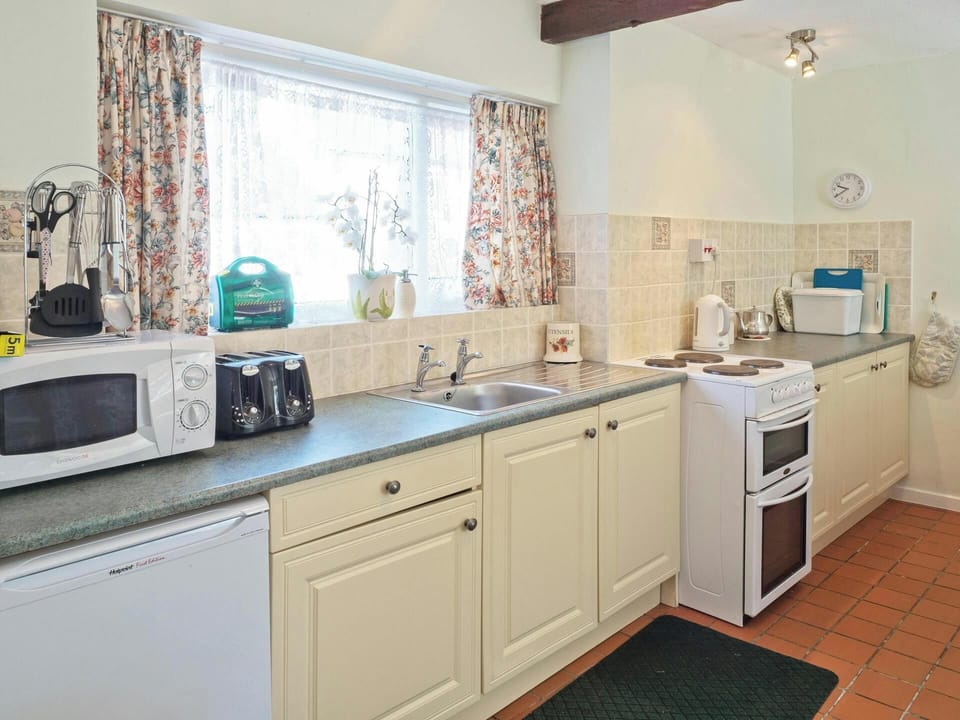 Base cupboards with electric cooker and under counter fridge