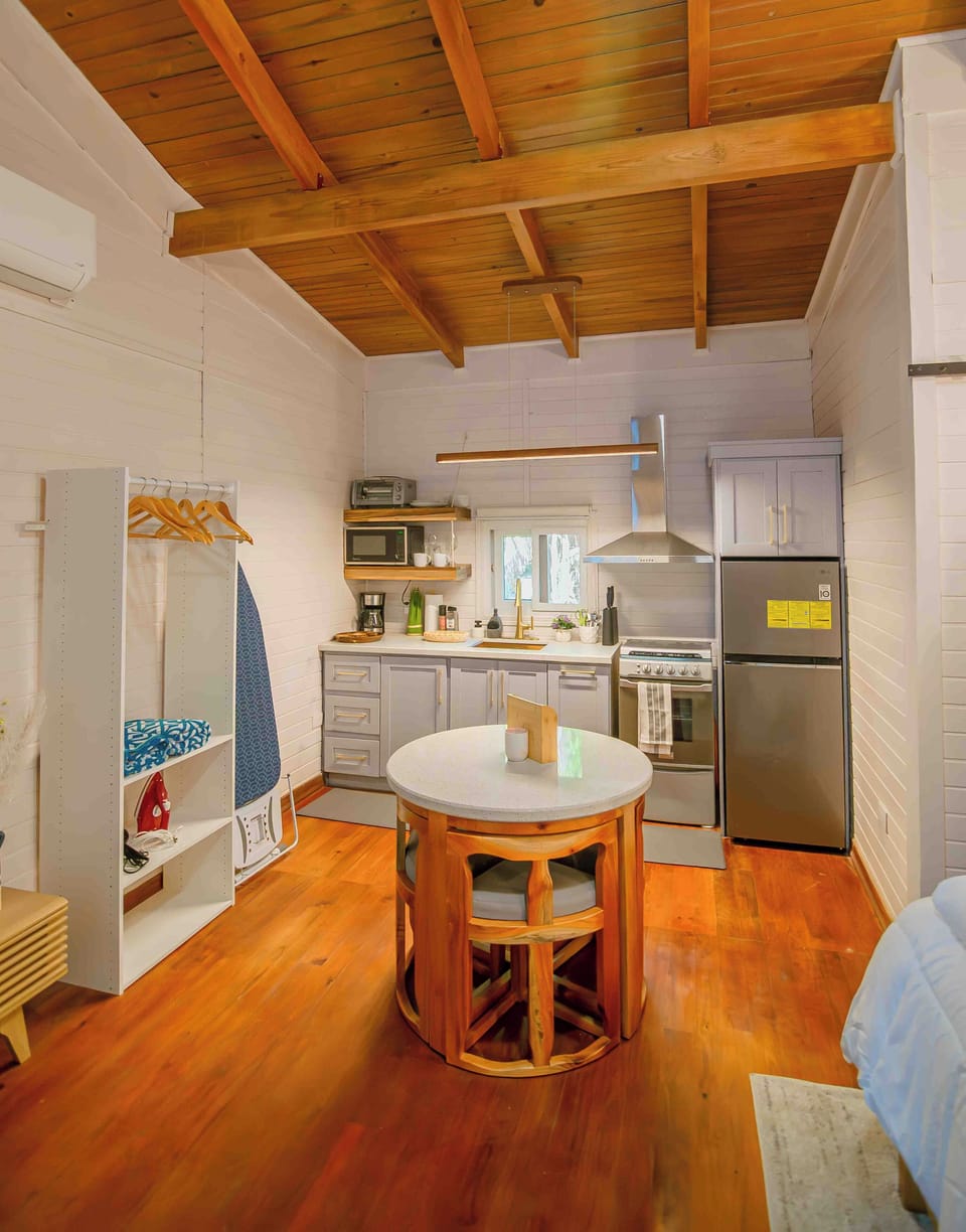 This inviting space combines living, dining, and sleeping areas in one. 