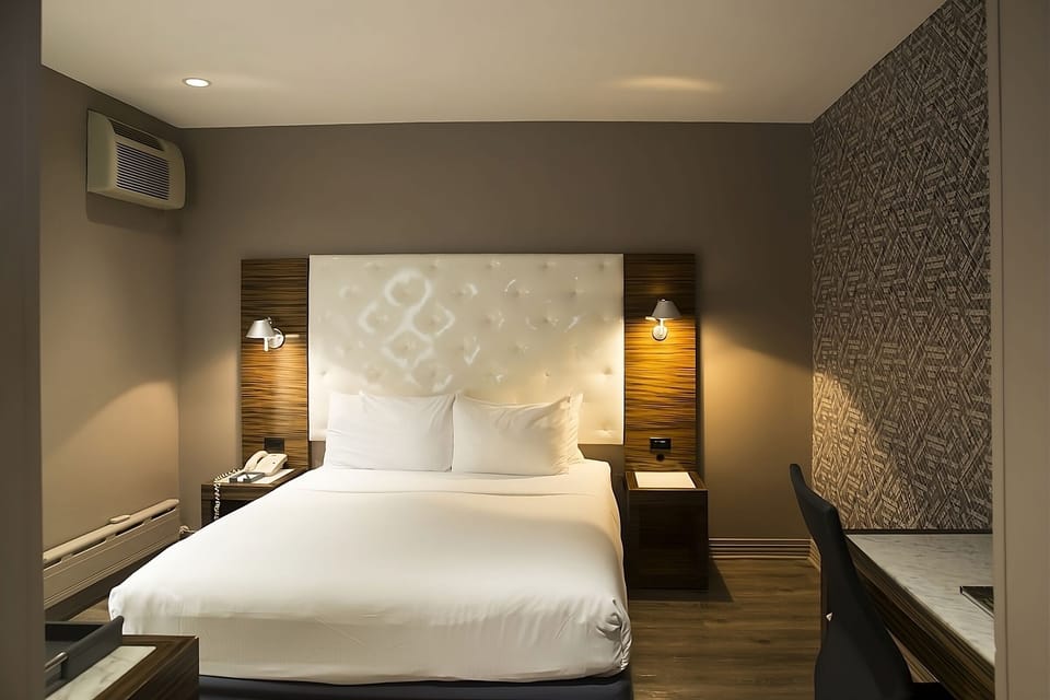 Recharge in a cozy king room with warm evening lighting.