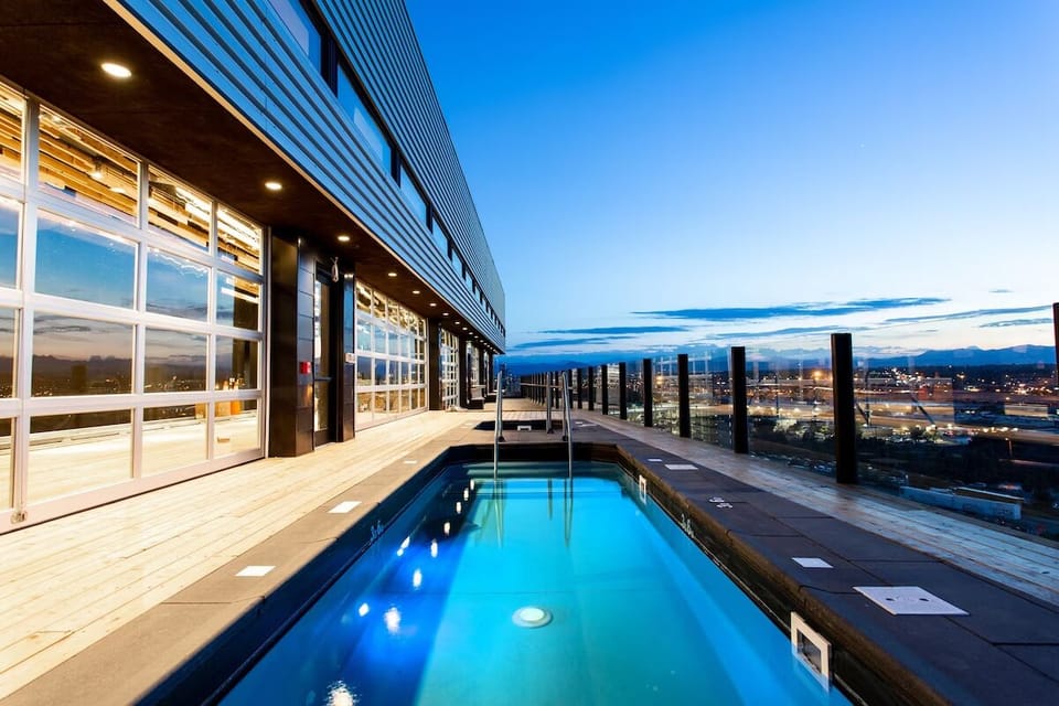 Unwind in the rooftop pool as city lights sparkle below