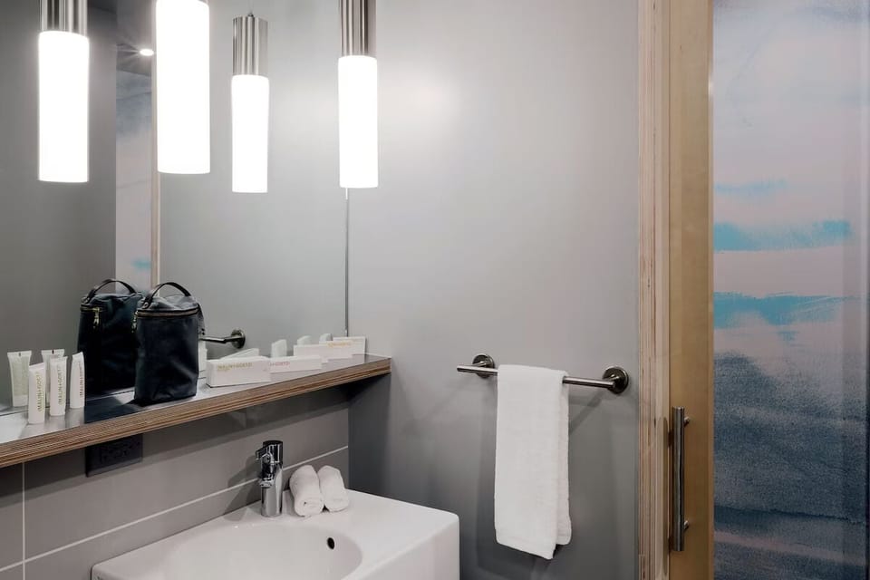 Refresh easily with bright vanity lighting and plush towels ready.