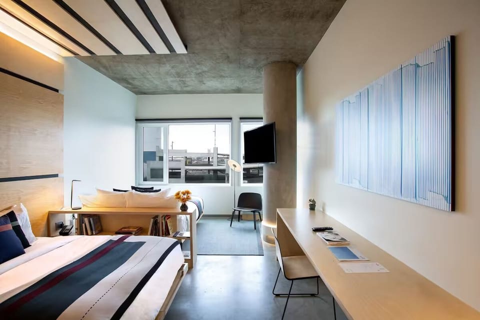 Unwind in a sunlit room with workspace and city views.