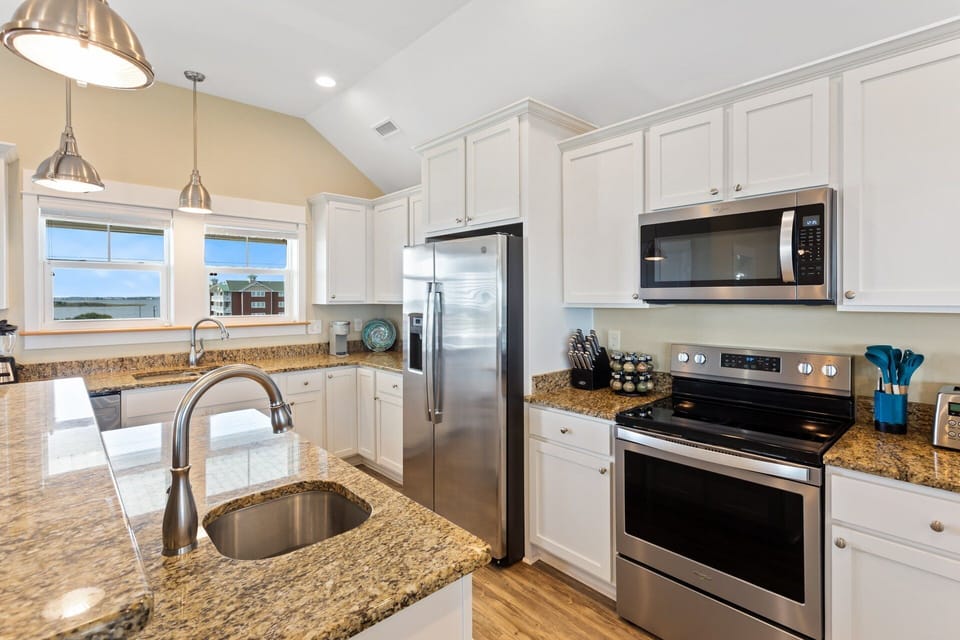 Whip up something delicious in the state-of-the-art Kitchen featuring elegant granite countertops and gleaming stainless steel appliances.