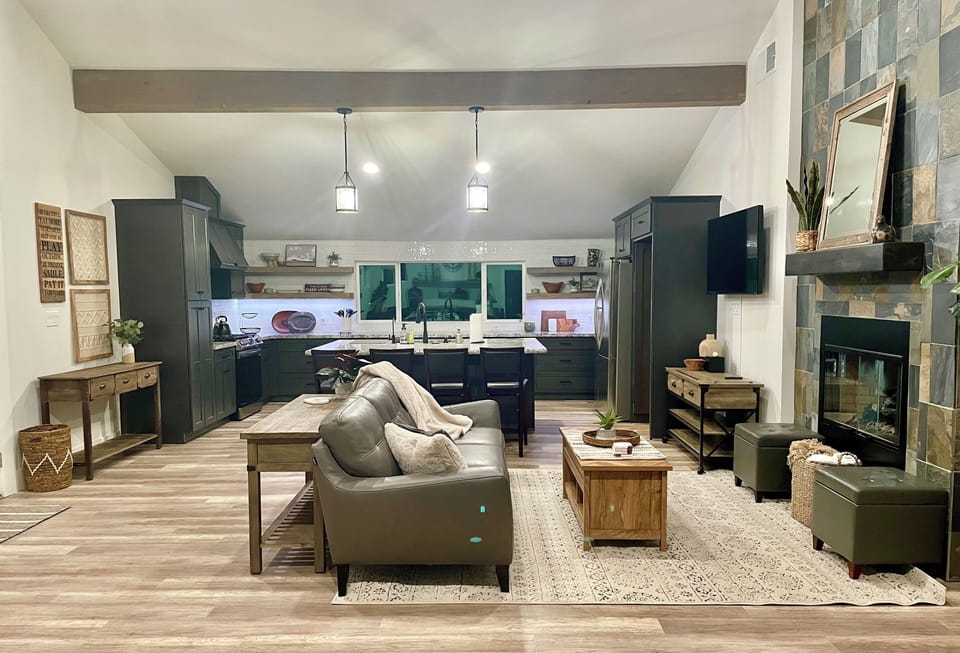 Open floor plan living room/kitchen has tons of storage and beautiful beams