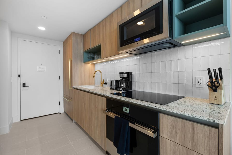 The kitchen is a culinary haven with its modern design and top-quality appliances.