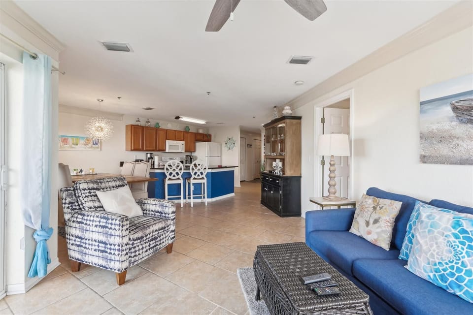 - Living area flows effortlessly into the kitchen with open layout  
- Stylish blue accents bring a coastal charm to the bright space  
- Comfortable seating and modern touches create a welcoming vibe 