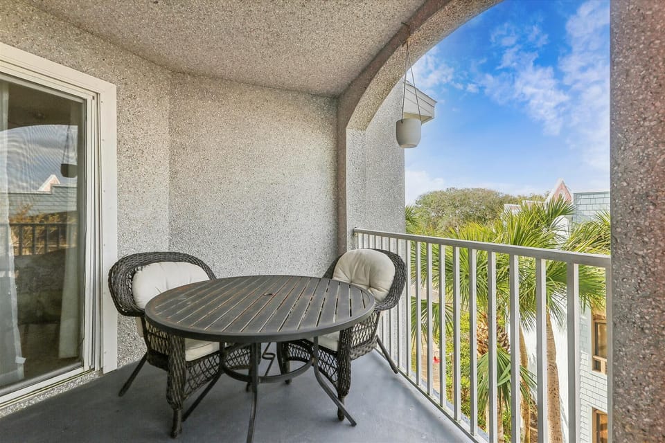 - Balcony seating with round table and chairs overlooking palm-filled views  
- Enjoy quiet moments while soaking up the sunny coastal surroundings  
- A cozy outdoor retreat perfect for meals, reading, or relaxing anytime 