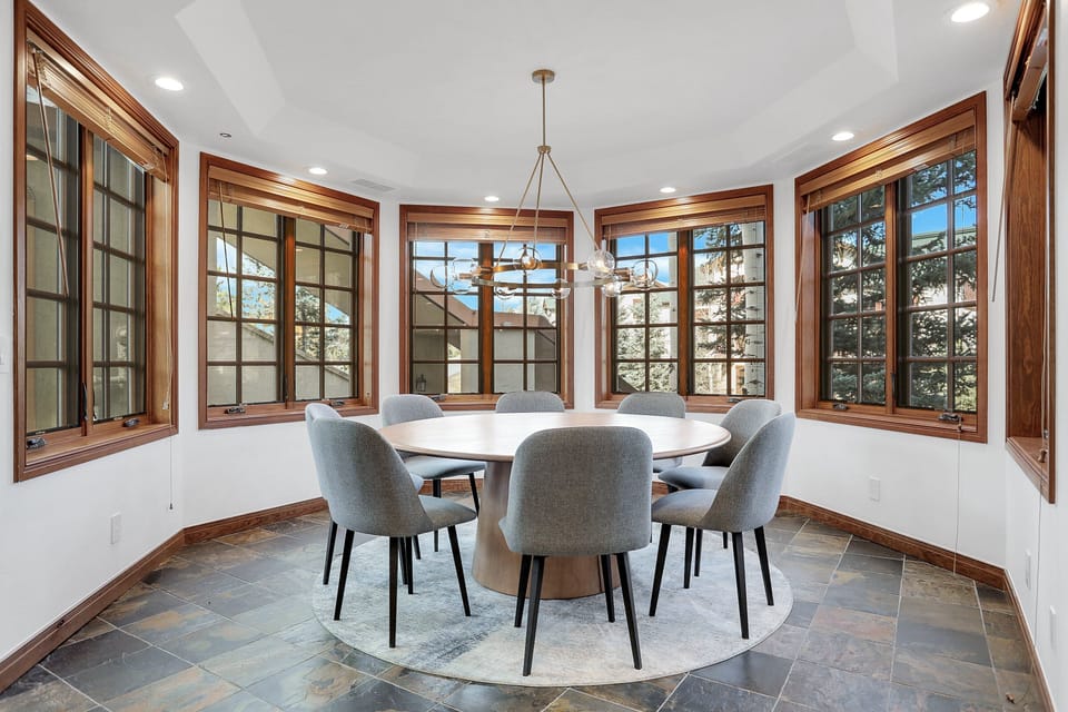 Beautiful Dining Nook with large round table and unique windows