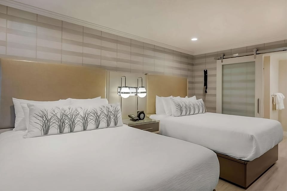 Stretch out on crisp linens under warm, ambient bedside lighting.