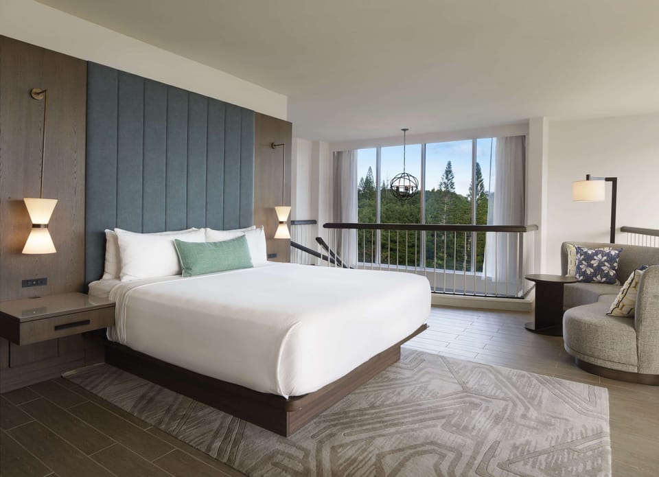 Drift off in a plush bed with calming treetop views.