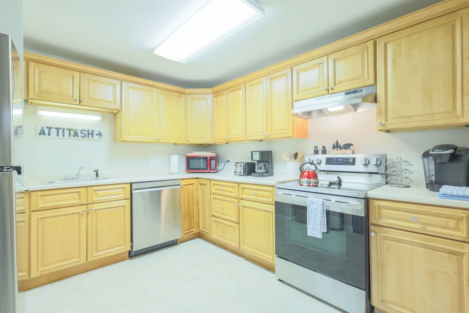 Kitchen is fully equipped with dishware, flatware, glassware, cooking utensils and pots & pans