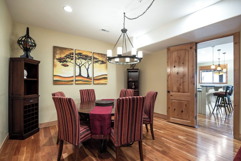 - Dining room with seating for six and striped chairs  
- Wall art and chandelier create inviting ambiance  
- Perfect for group dinners and celebrations