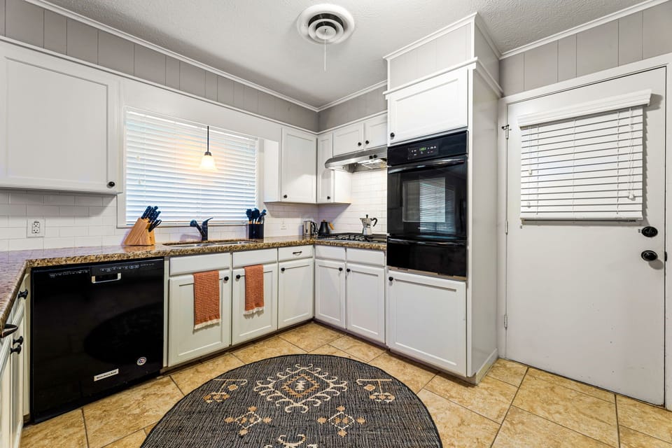 The kitchen is equipped with a window with blinds