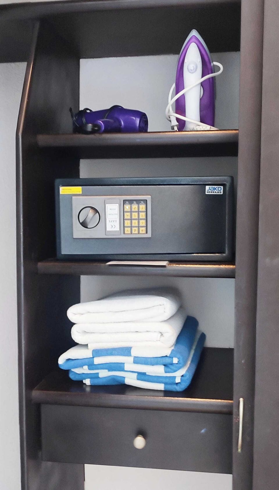 Closet with Laptop safe, iron and hair dryer. Beach and bath towels