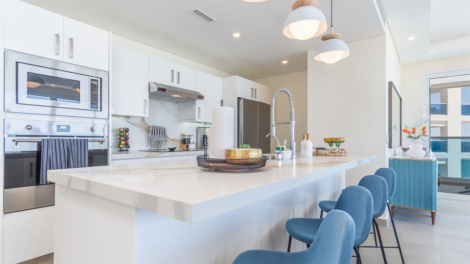 the kitchen with tis bar stool seating