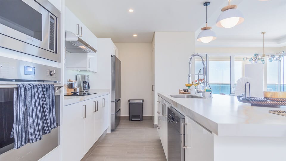 the kitchen is long and well laid out, full of all needed appliances
