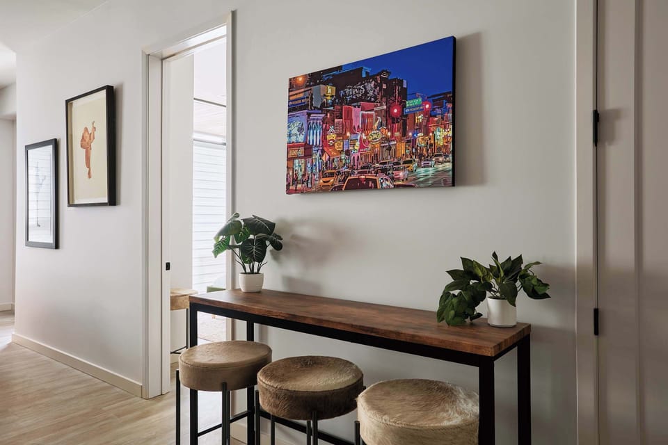Hallway decor featuring local art and chic furnishings, creating a warm and inviting atmosphere throughout the home.