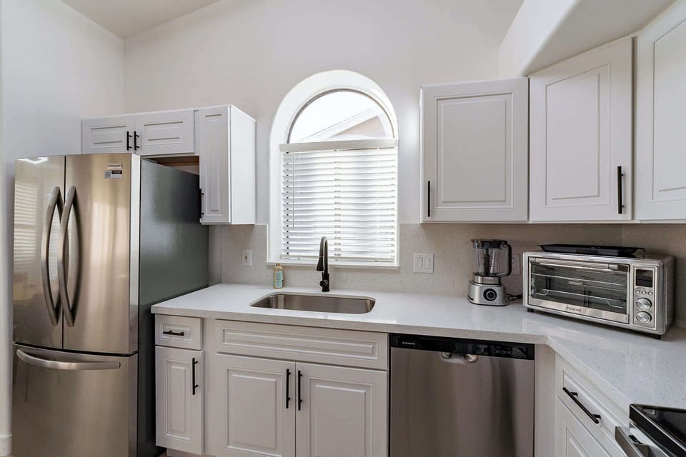 Fully equipped, modern kitchen with stainless steel appliances.