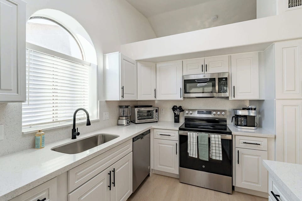 Fully equipped, modern kitchen with stainless steel appliances.