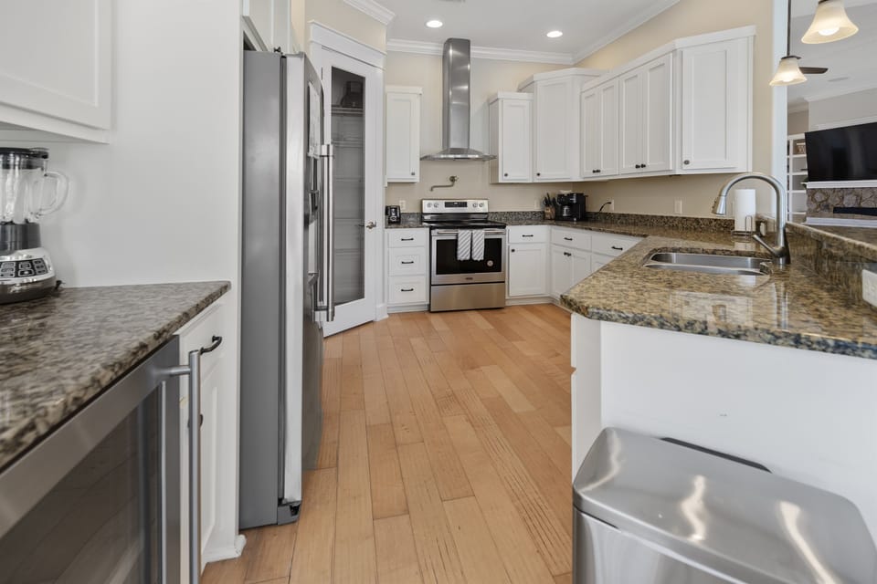 Your spacious kitchen features granite counters, modern appliances, and crisp white cabinets—perfect for preparing meals together.