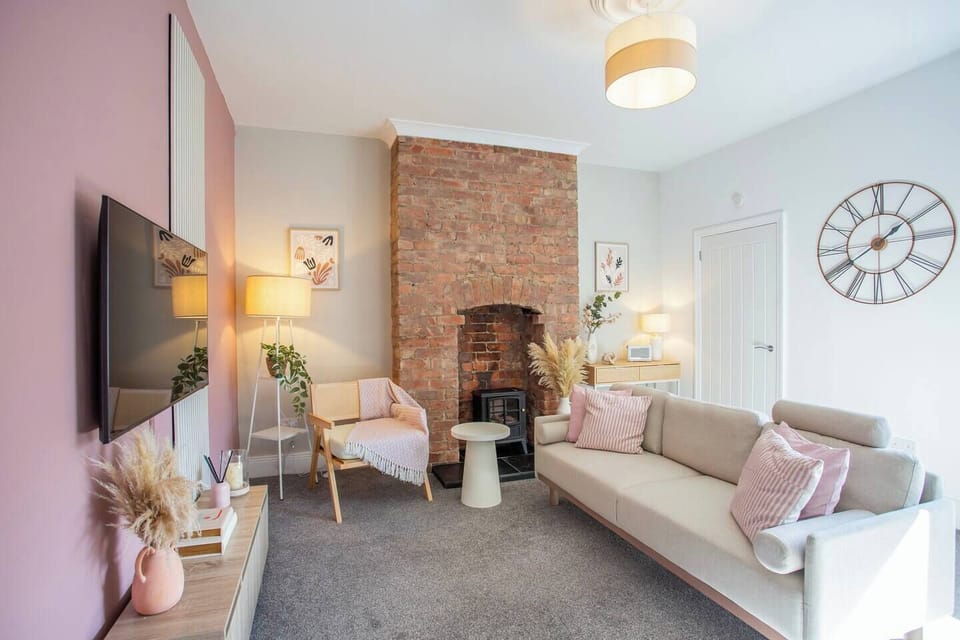 This living room features a bright and airy atmosphere, with its crisp white walls and matching white sofas that create a clean and elegant look.