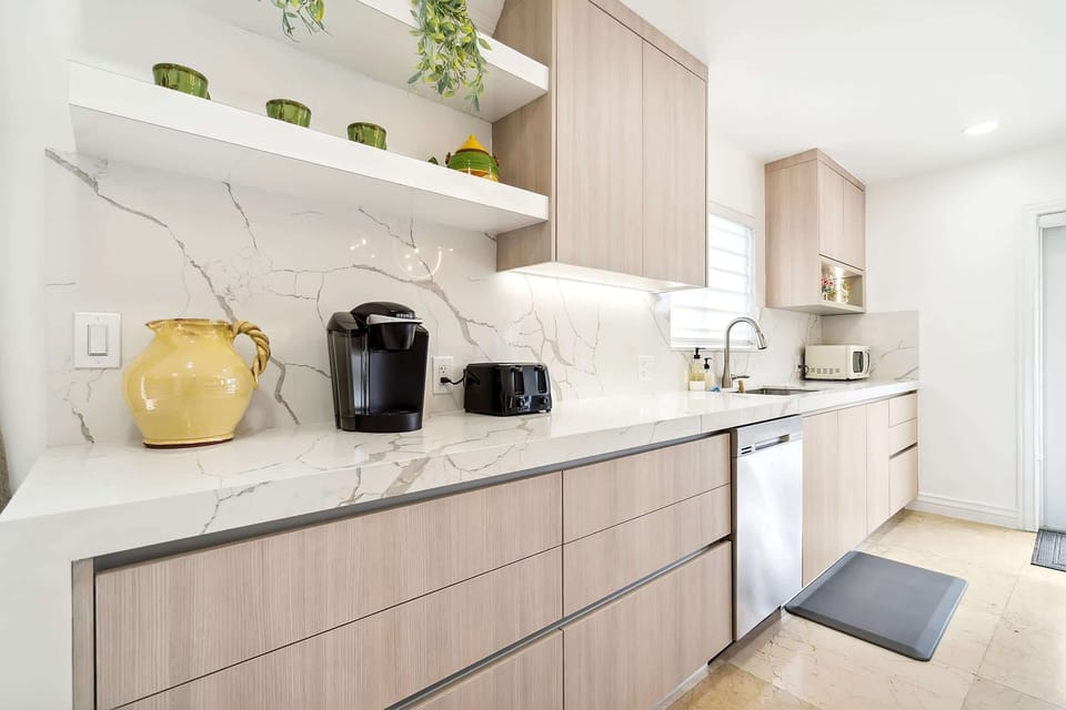 With a functional layout, a center kitchen island, and a plethora of kitchen appliances, this custom-made kitchen has everything you need to unleash your culinary creativity.