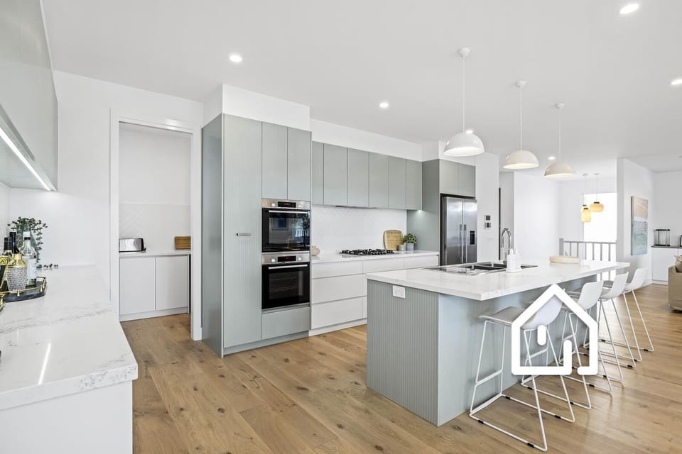A HUGE butler’s pantry is tucked away at the back of this gourmet kitchen 
