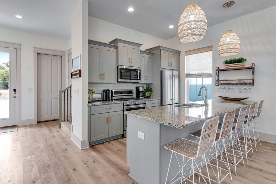Stocked kitchen with countertop bar seating for four. 