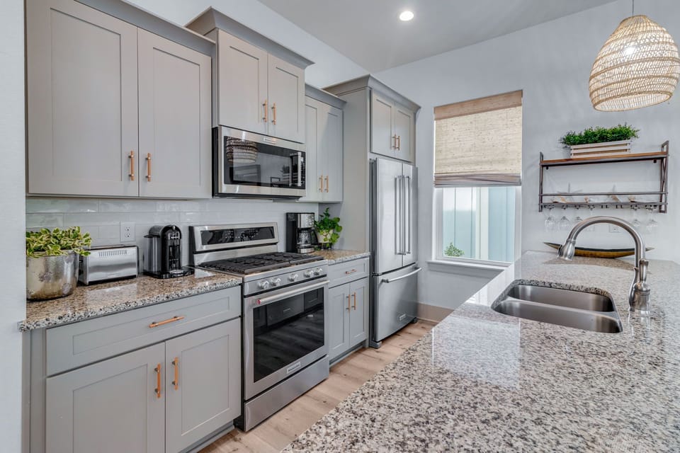 Stocked kitchen with countertop bar seating for four. 