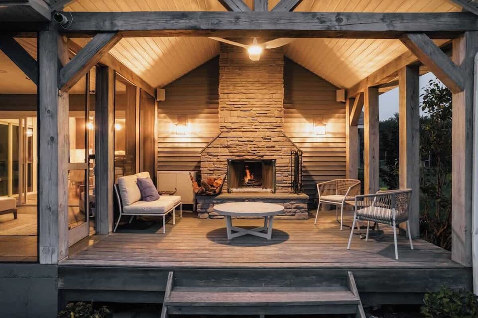 EVENING HANGOUT- Covered deck with wood burning fireplace, accent lighting, fan and exterior speakers tied into sound system.  Porches are winterized. Message host for details. 