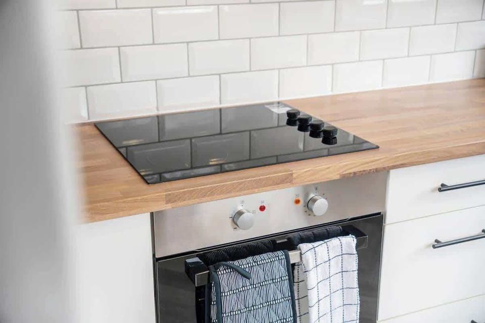 Kitchen equipped with all essentials, including a washer & dryer, oven, fridge and full cookware set.