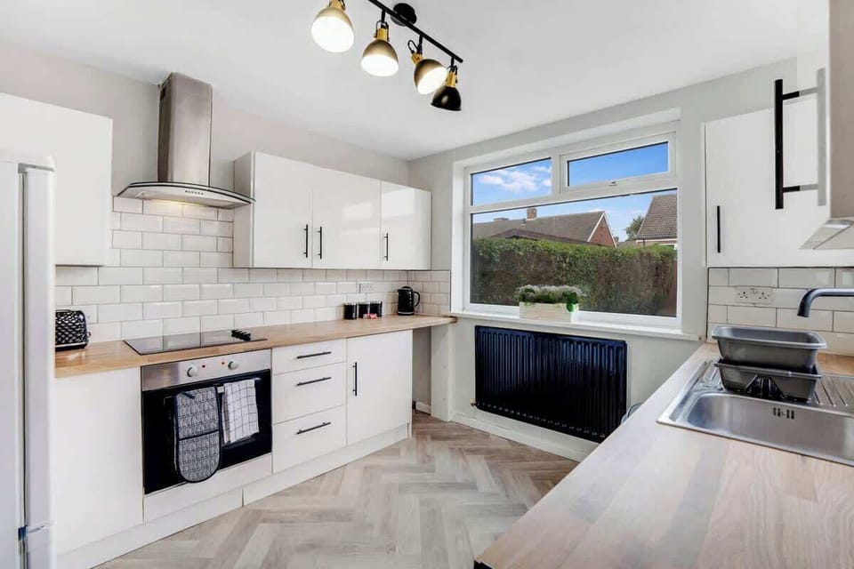 Kitchen equipped with all essentials, including a washer & dryer, oven, fridge and full cookware set.
