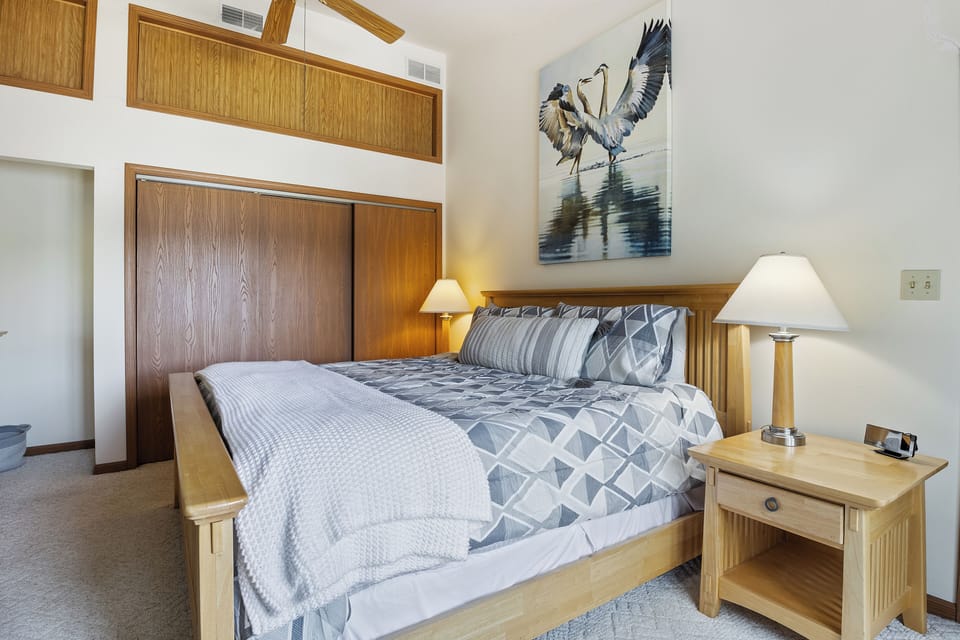 Relax in this serene bedroom featuring comfortable bedding and calming décor—your perfect retreat for a peaceful night's sleep.