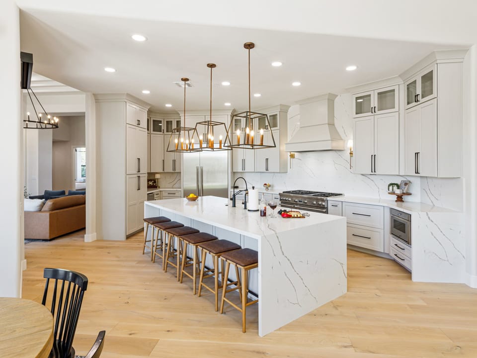 Fully equipped kitchen with stainless steel appliances, a Scotsman Ice Maker, and bar seating for 6 guests.