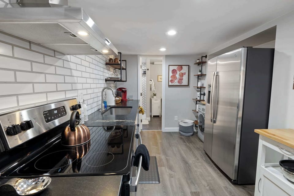 The full kitchen has all stainless appliances.