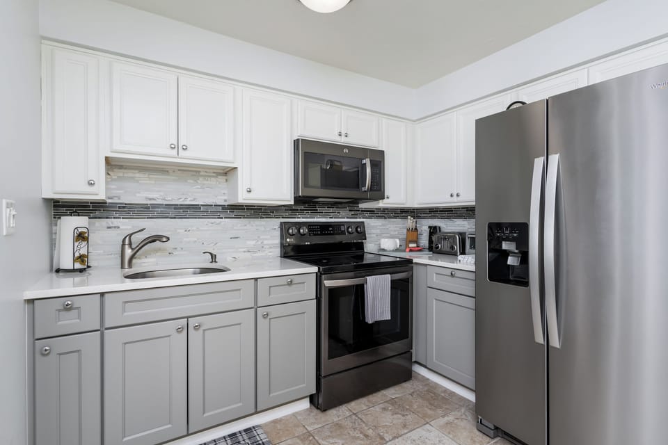 Stove, oven, microwave, refrigerator, utensils, pots, pans, dishes, glasses