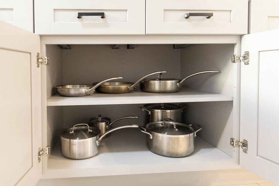 The kitchen is well stocked with cookware, utensils, silverware, and glassware. 