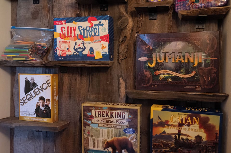 - Game nook with board games for fun indoor activities   - Enjoy classics like Jumanji and adventure favorites   - Entertainment for family nights and cozy days in