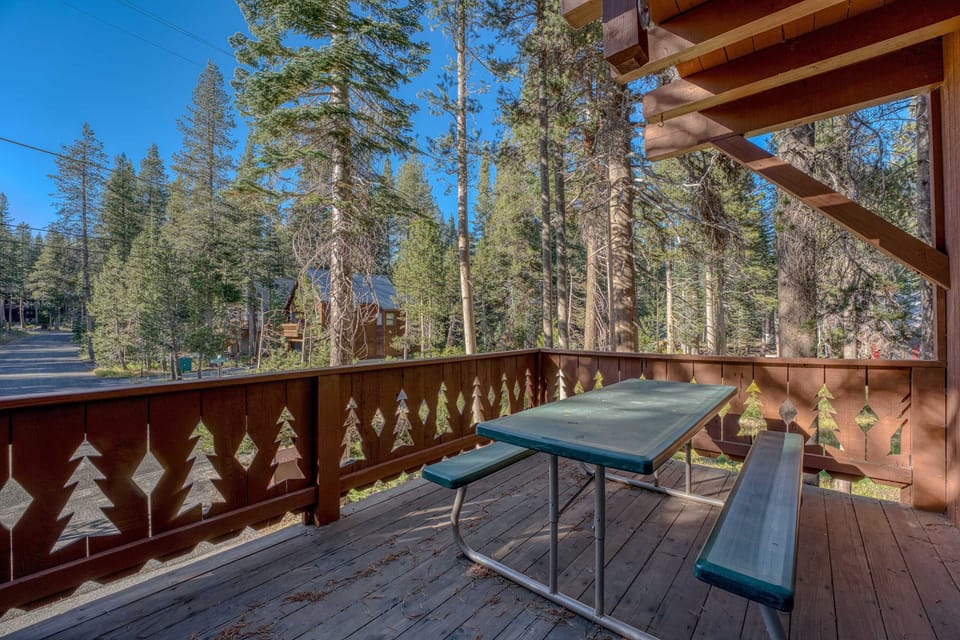 Exterior: Deck, outdoor dining, gas BBQ grill, forested views
