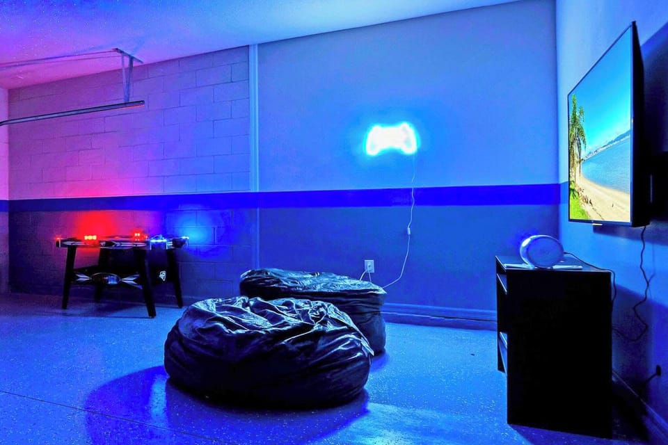 Garage-turned-games-room with cool mood lighting