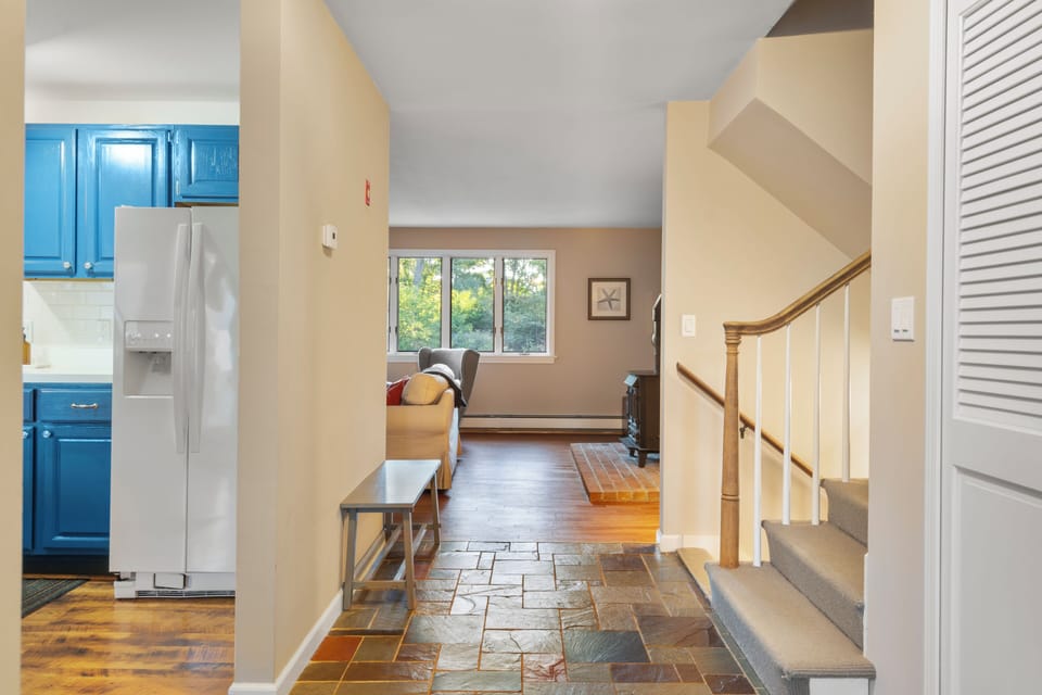 The entryway connects the kitchen, stairs, and living room